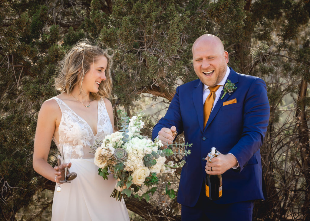 Aimee & Justin's Real Wedding at Lovers Knoll and Merry GO Round Sedona, Arizona - Opening the Champagne