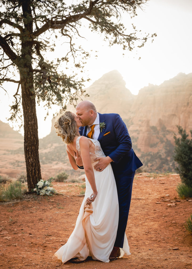 Aimee & Justin's Real Wedding at Lovers Knoll and Merry GO Round Sedona, Arizona - Leaning in for a Kiss