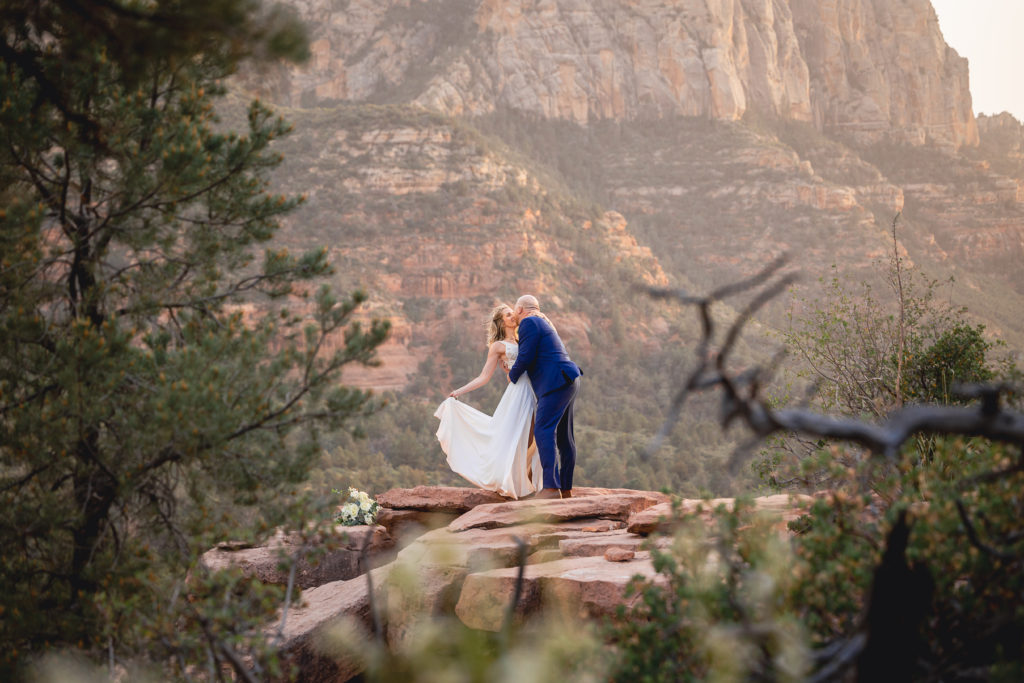 Aimee & Justin's Real Wedding at Lovers Knoll and Merry GO Round Sedona, Arizona - Passionate Kiss